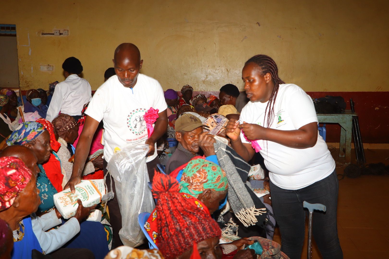 Volunteers handing out supplies to elders